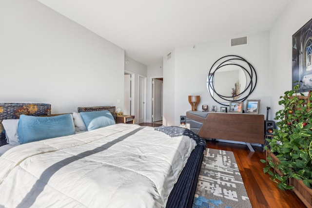 bedroom with dark wood-type flooring