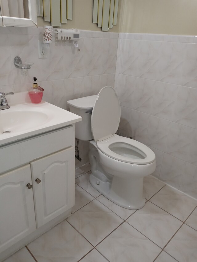 bathroom with toilet and tile walls