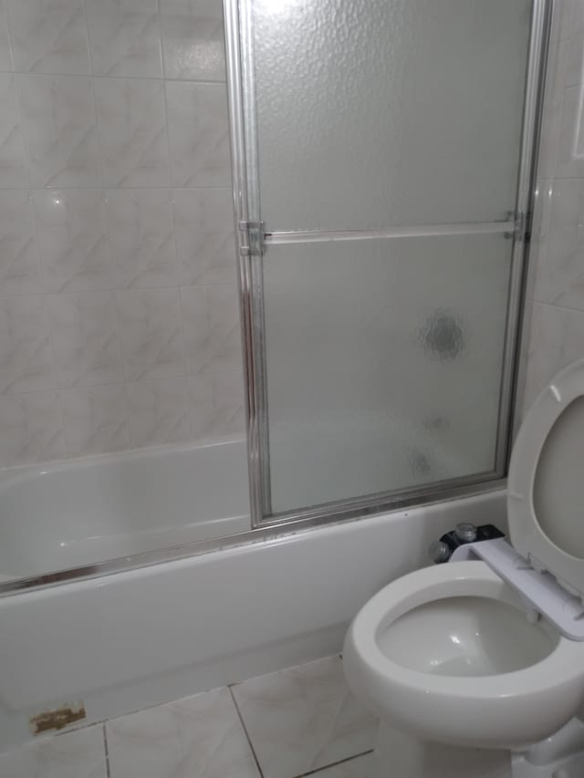 bathroom featuring a shower with shower door