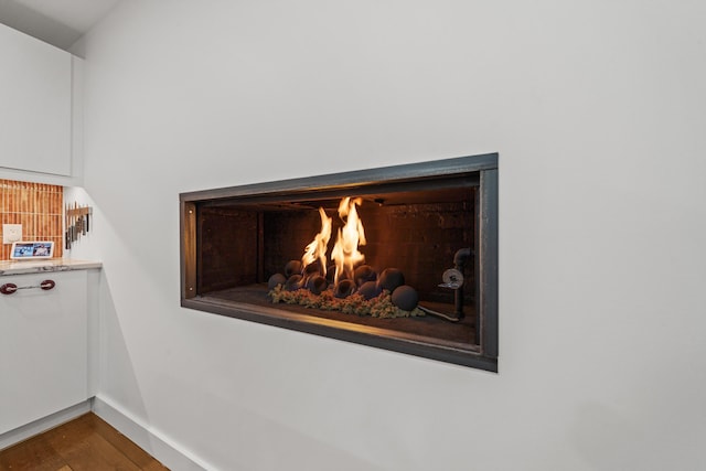 room details featuring hardwood / wood-style floors and backsplash