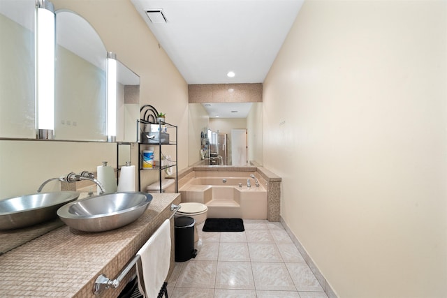 full bath with visible vents, vanity, tile patterned flooring, baseboards, and a bath