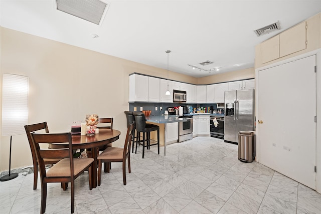 dining space with marble finish floor and visible vents