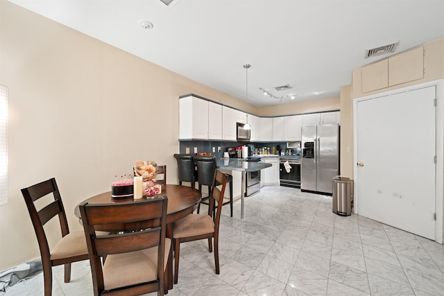 dining space with marble finish floor and visible vents