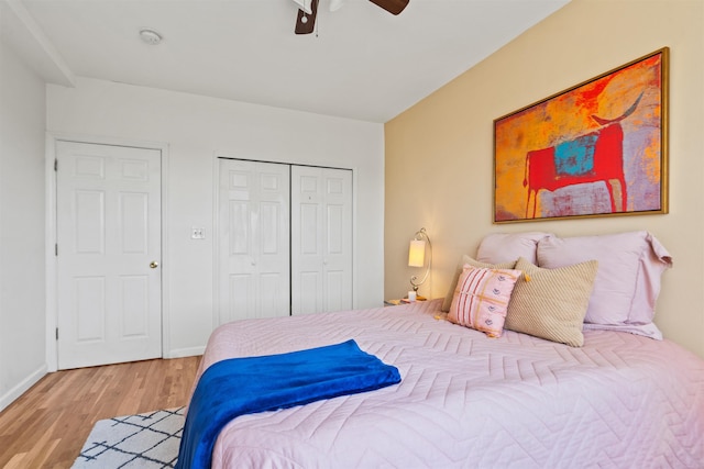 bedroom featuring a closet, baseboards, ceiling fan, and wood finished floors
