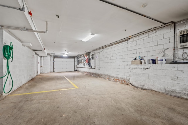 garage with concrete block wall and heating unit