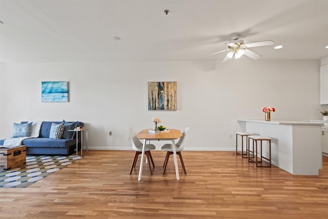 dining space with recessed lighting, a ceiling fan, baseboards, and light wood finished floors