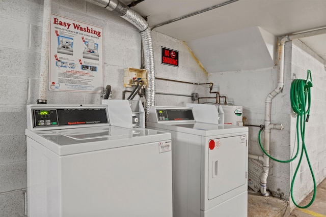 common laundry area featuring separate washer and dryer, water heater, and concrete block wall