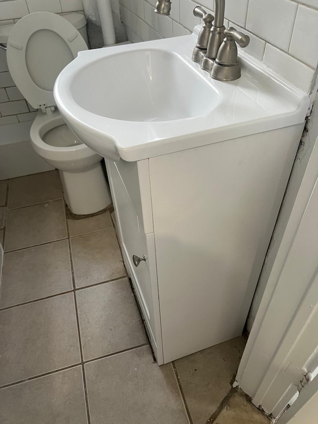 bathroom with toilet, tile patterned floors, and vanity