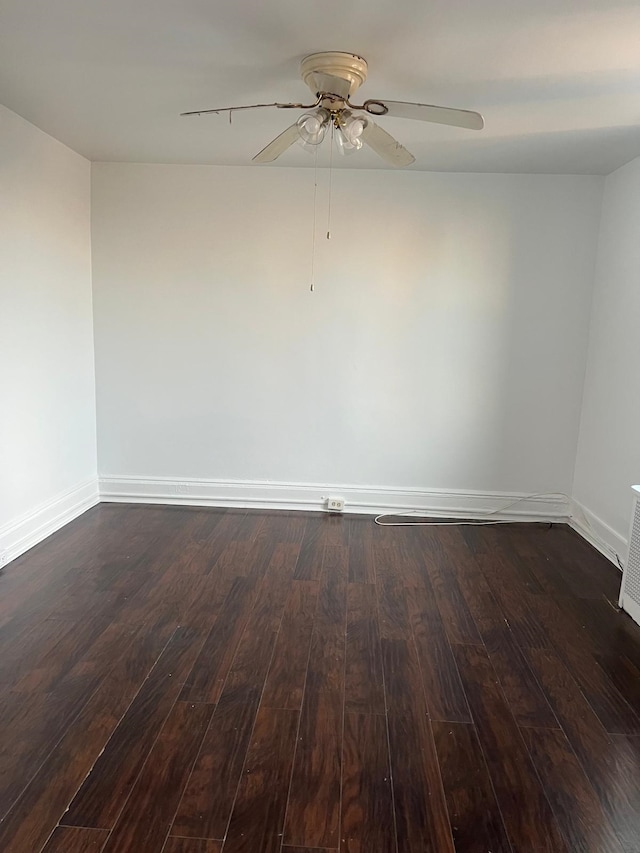 unfurnished room featuring dark hardwood / wood-style floors and ceiling fan