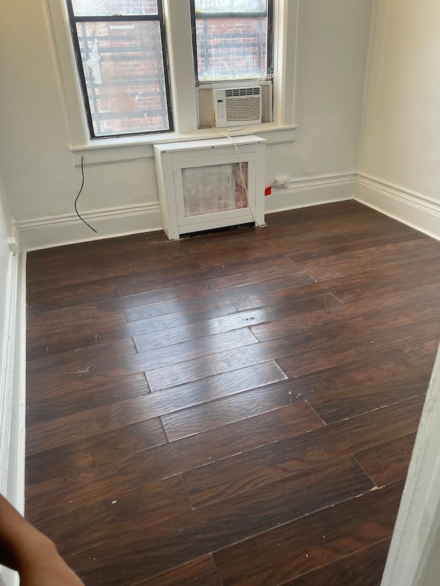 spare room with baseboards and cooling unit