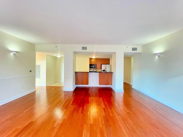 unfurnished living room featuring wood-type flooring