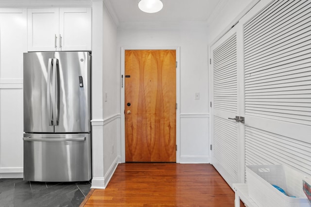 501 9th St Unit 407, Hoboken, NJ 07030 - kitchen with freestanding refrigerator, crown molding, white cabinets, wood finished floors, and a wainscoted wall