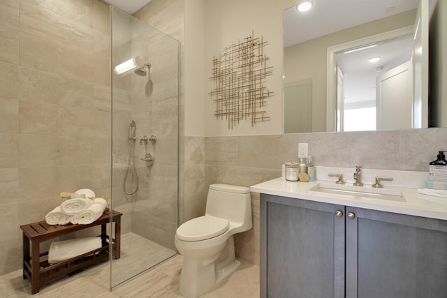 bathroom featuring toilet, vanity, tile walls, and tiled shower