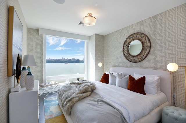 bedroom featuring a water view