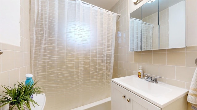 full bathroom featuring shower / bath combination with curtain, vanity, backsplash, and tile walls