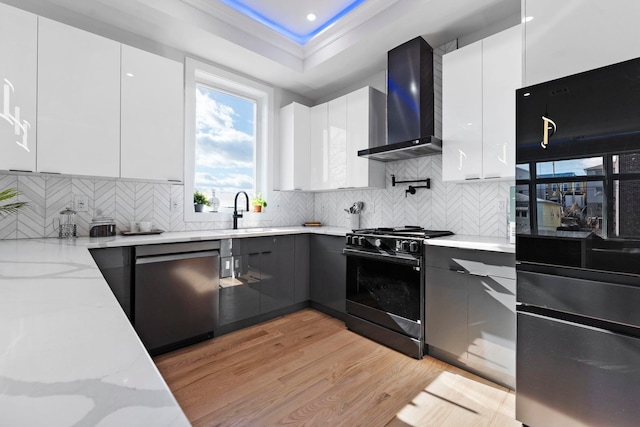 93 Terrace Ave Unit 2, Jersey City, NJ 07037 - kitchen with freestanding refrigerator, wall chimney exhaust hood, gas range, stainless steel dishwasher, and modern cabinets