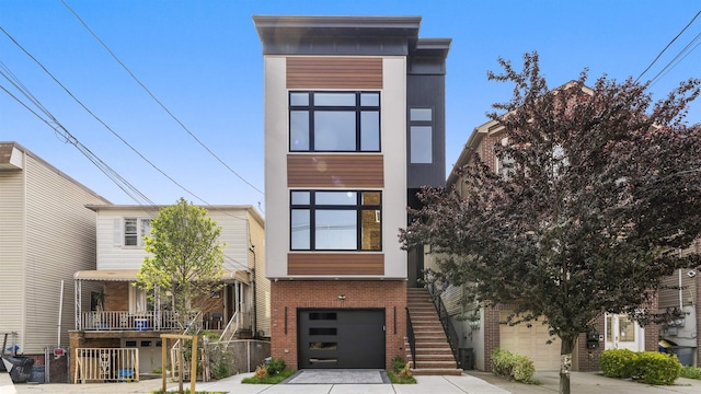 93 Terrace Ave Unit 2, Jersey City, NJ 07037 - modern home featuring brick siding, a garage, stairway, and driveway