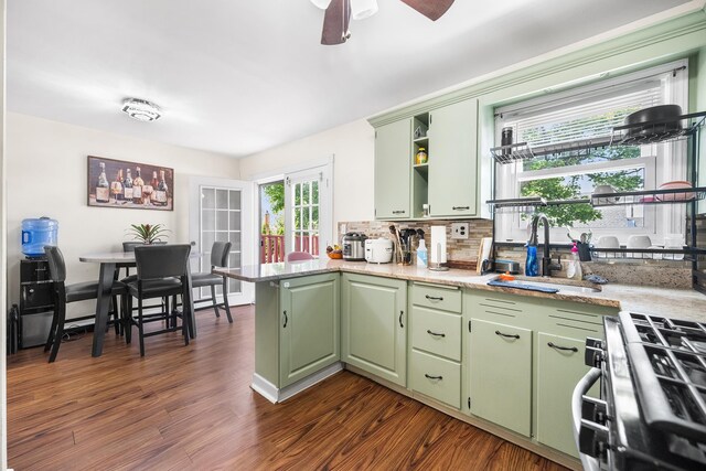 120 Main St, Ridgefield Park, NJ 07660 - kitchen with green cabinets, stainless steel gas stove, a peninsula, open shelves, and a sink