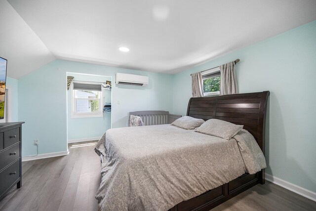 120 Main St, Ridgefield Park, NJ 07660 - bedroom featuring a wall mounted air conditioner, dark wood-style floors, baseboards, recessed lighting, and vaulted ceiling