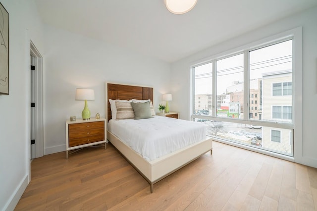 bedroom featuring baseboards and wood finished floors