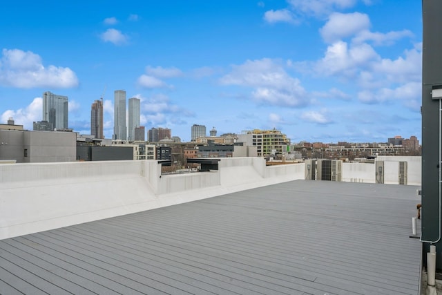 wooden terrace featuring a view of city