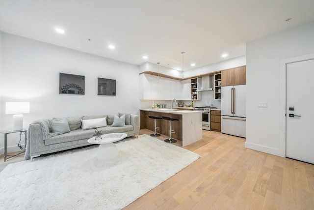 living room featuring light wood finished floors and recessed lighting