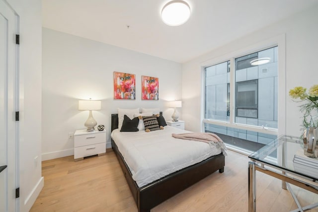 bedroom featuring light wood-style flooring and baseboards