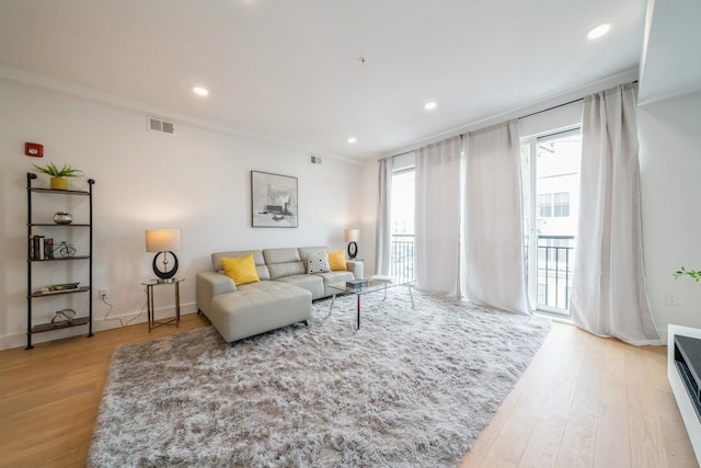 living area with visible vents, wood finished floors, and recessed lighting