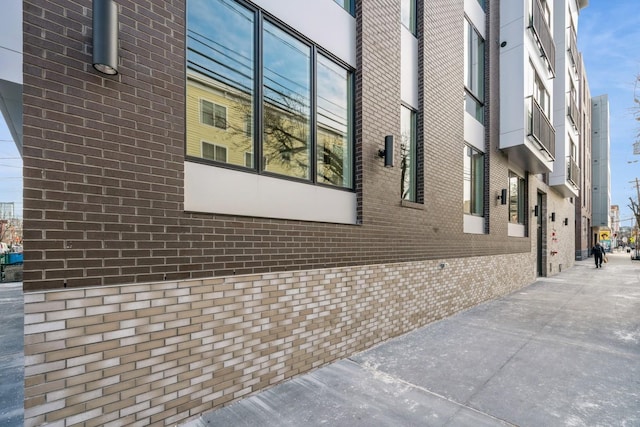 view of property exterior featuring brick siding
