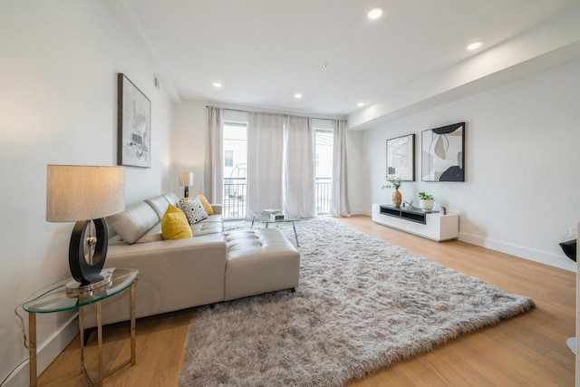 living area featuring recessed lighting, baseboards, and wood finished floors