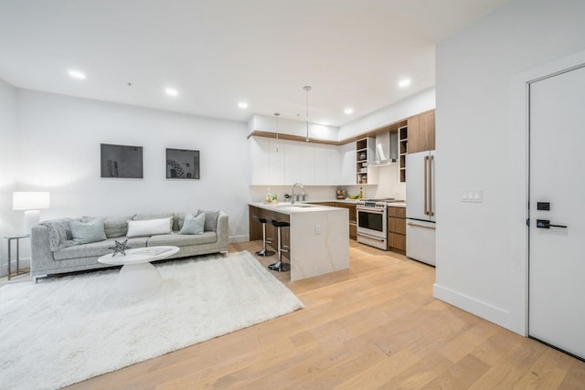 living room with light wood-type flooring, baseboards, and recessed lighting