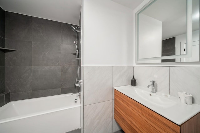 bathroom featuring shower / bath combination, tile walls, and vanity