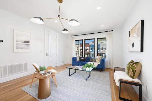 77 Clerk St Unit 1, Jersey City, NJ 07305 - living room with wood finished floors, visible vents, and recessed lighting