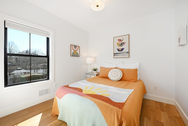 77 Clerk St Unit 1, Jersey City, NJ 07305 - bedroom featuring baseboards, visible vents, and light wood-style flooring