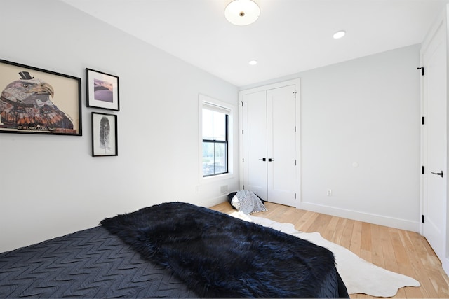 77 Clerk St Unit 1, Jersey City, NJ 07305 - bedroom with light wood-style flooring, baseboards, recessed lighting, and a closet
