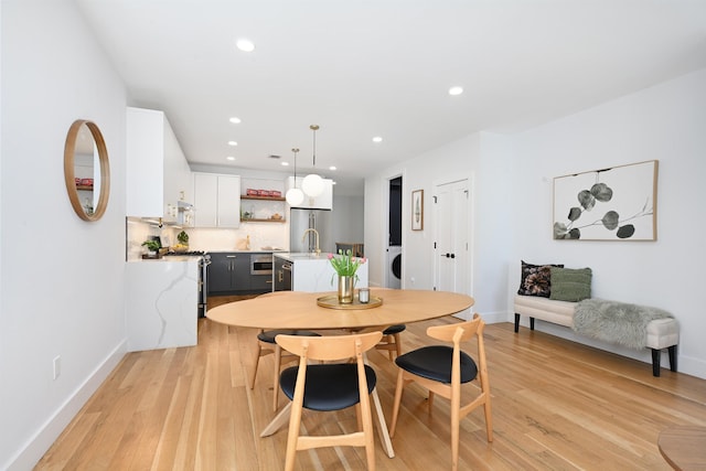 77 Clerk St Unit 1, Jersey City, NJ 07305 - dining room with light wood finished floors, baseboards, recessed lighting, and washer / clothes dryer