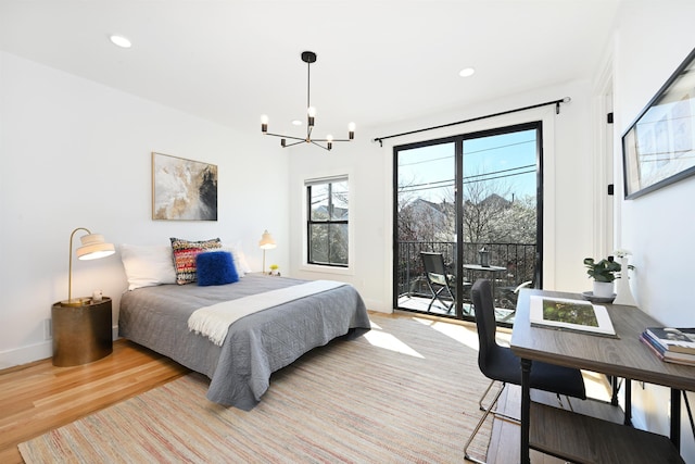 77 Clerk St Unit 1, Jersey City, NJ 07305 - bedroom with recessed lighting, access to exterior, an inviting chandelier, and light wood-style flooring