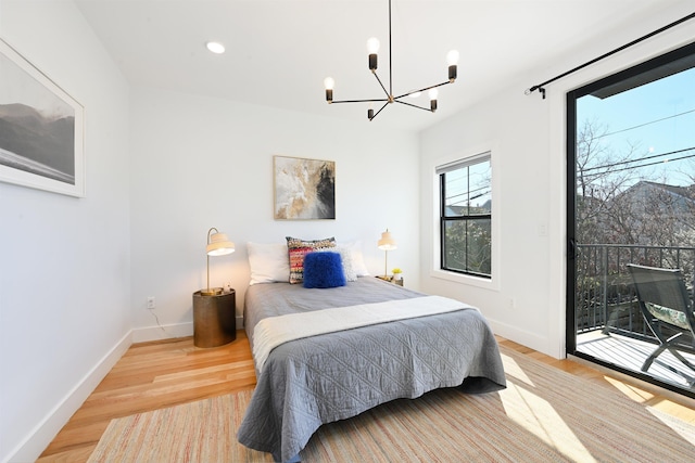 77 Clerk St Unit 1, Jersey City, NJ 07305 - bedroom with a chandelier, baseboards, recessed lighting, wood finished floors, and access to outside