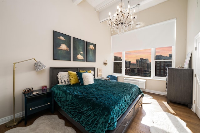 1500 Hudson St Unit 7R, Hoboken, NJ 07030 - bedroom with a chandelier, wood finished floors, an AC wall unit, and a towering ceiling