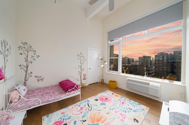 1500 Hudson St Unit 7R, Hoboken, NJ 07030 - bedroom with a wall mounted air conditioner, wood finished floors, a city view, and ceiling fan