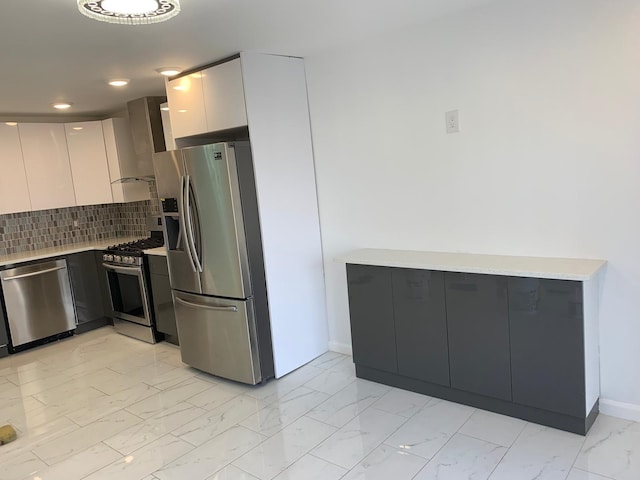 1604 74th St Unit 202, North Bergen, NJ 07047 - kitchen with appliances with stainless steel finishes, modern cabinets, light countertops, light marble finish flooring, and baseboards