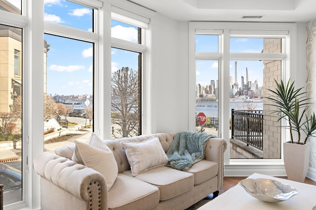 sunroom featuring a healthy amount of sunlight and a water view