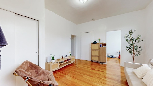 sitting room with wood-type flooring and baseboard heating