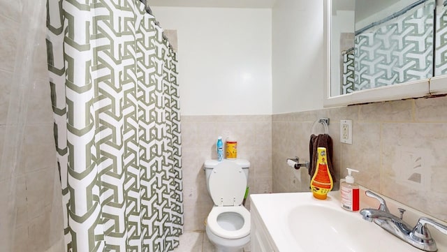 bathroom featuring toilet, vanity, tile walls, and curtained shower