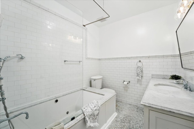 821 Washington St Unit 5, Hoboken, NJ 07030 - bathroom with vanity, tile patterned floors, a wainscoted wall, washtub / shower combination, and tile walls