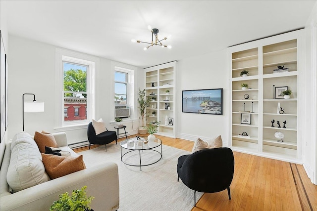821 Washington St Unit 5, Hoboken, NJ 07030 - living area with light wood-style floors, a chandelier, built in shelves, and cooling unit