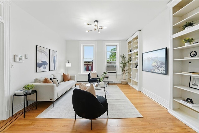 821 Washington St Unit 5, Hoboken, NJ 07030 - living room featuring light wood-style flooring, cooling unit, a chandelier, and a baseboard heating unit
