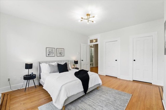 821 Washington St Unit 5, Hoboken, NJ 07030 - bedroom with wood finished floors, a chandelier, and multiple closets