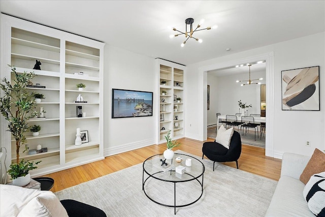 821 Washington St Unit 5, Hoboken, NJ 07030 - living area featuring a chandelier, light wood-style floors, and built in shelves