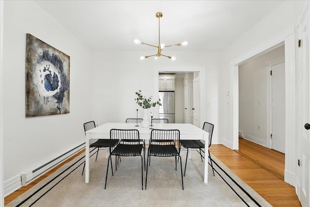 821 Washington St Unit 5, Hoboken, NJ 07030 - dining room featuring a baseboard heating unit, a chandelier, and light wood-style floors